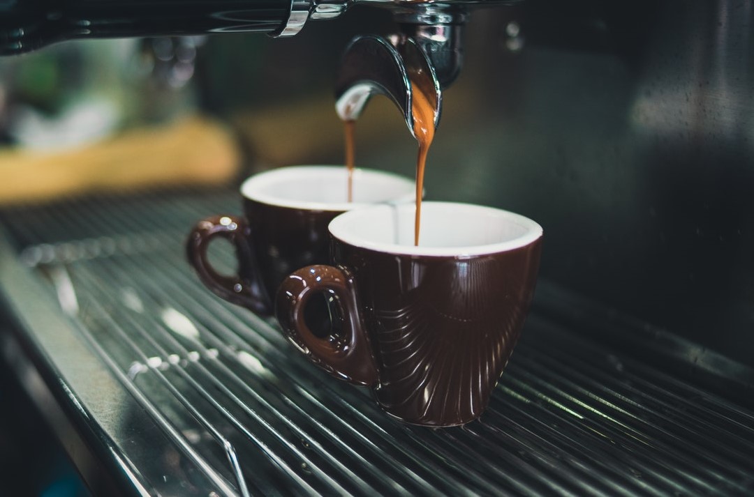 Coffee beans poured into 2 cups